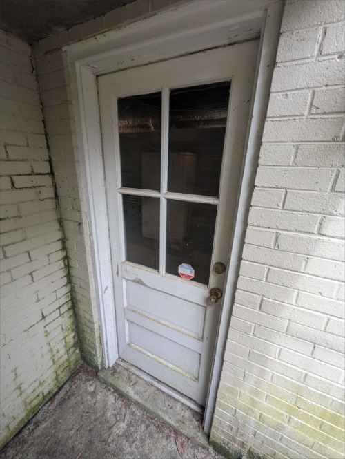 Door Replacement 01: Old door that is improperly sealed and letting water enter basement.