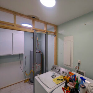 Laundry Room Renovation photo 3: The new wall in the laundry room is fully framed and the pocket door framing is installed.