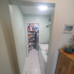 Laundry Room Renovation photo 9: Completed laundry room renovation with door open leading to the pantry